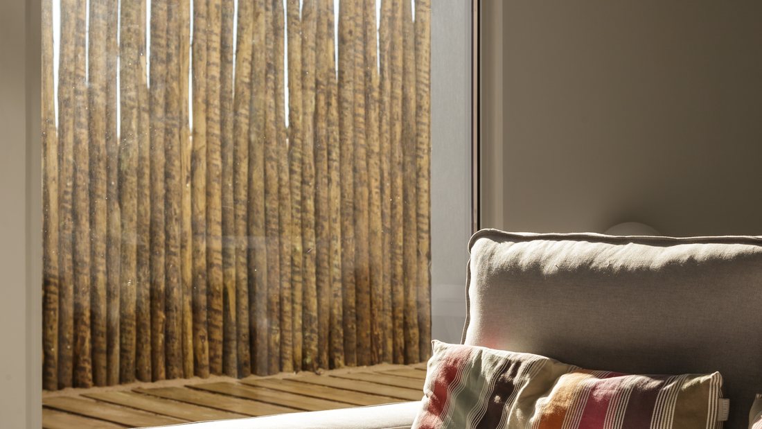 Living room seating beside a tall privacy-filmed window